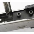 AK-Builder black oxide steel rail alignment fixture installed in unfinished stamped AK receiver, with leveling tool.